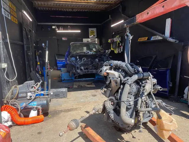 Engine and gearbox removed from a blue car in the BLS Ecoboosts workshop in Maidstone